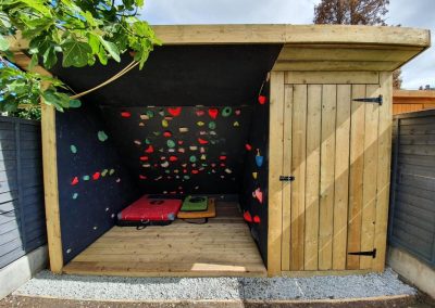 Climbing wall on left and small shed place on the left